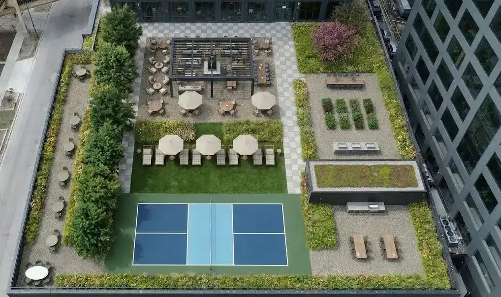 Pickleball court at Stead 220 with rooftop seating and landscaped terrace area